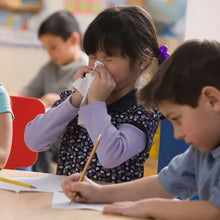 Child using a facial tissue, with a tissue held near the face