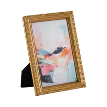 Gold beaded tabletop picture frame, angled with abstract artwork and easel stand
