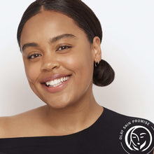Smiling woman with Olay skin promise seal icon