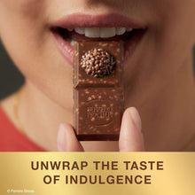 Ferrero Rocher milk hazelnut chocolate bar piece held with bite showing filling