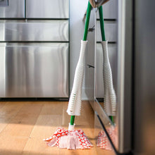 Pair of microfiber mop heads with red-and-white patterned cloth on green handles