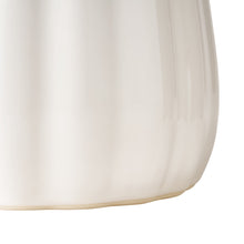 White stoneware utensil holder close-up of fluted sides and rounded base