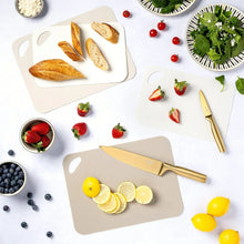 Cream poly cutting mat with side handle cutout, flat on a countertop