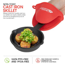 Mini cast iron skillet with cooked egg and greens, plus a red silicone mitt