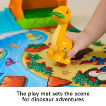 Orange dinosaur figure on a colorful jungle play mat with water and flowers