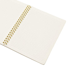 Ruled notebook pages with gold spiral binding