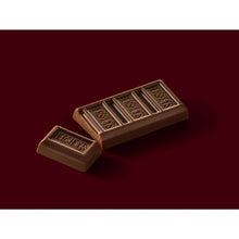 Milk chocolate bar pieces with Hershey's logo, close-up