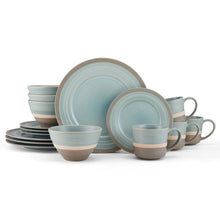 Stoneware dinnerware set with blue plates and mugs with beige bases.