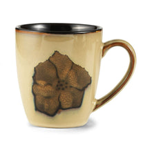 Stoneware coffee mug with black top rim and painted poppy flower in dark tones