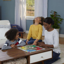 Family playing Sorry! board game on a coffee table with pawns on the board