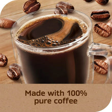 Glass mug filled with dark instant coffee, with crema and bubbles
