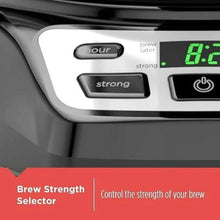 Brew strength selector and timer display on black programmable coffee maker