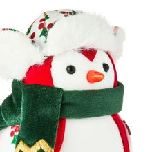 Close-up fabric bird with green scarf and red-white body, orange beak