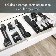 Black kitchen utensil set stored in a clear drawer organizer inside a kitchen drawer