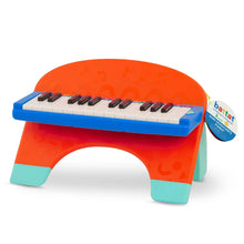 Mini musician's piano toy with black keys and open arch front