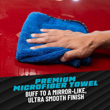 Blue microfiber towel buffing a red car hood after clay treatment