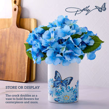 White stoneware crock with blue butterfly and floral print, filled with blue flowers