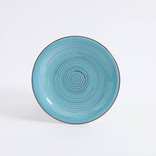 Blue ceramic dinner plate with red outer rim and concentric ring pattern