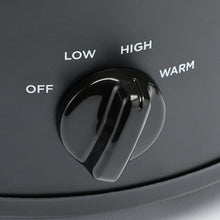 Manual slow cooker temperature dial labeled LOW, HIGH, OFF, and WARM on dark base