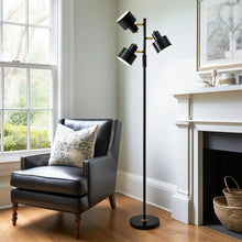 Black 3-head floor lamp with tilted shades, standing pole, and round foot base
