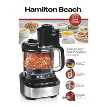 Black food processor with clear bowl and base, shown with multiple included blades and discs