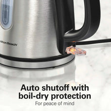Stainless steel electric kettle base area with side spout and black power cord