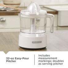 BLACK+DECKER manual citrus juicer with clear 32-oz pitcher and white base
