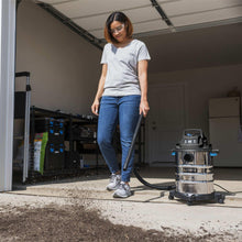 Hart wet/dry vacuum on wheels with hose connected in a garage setup