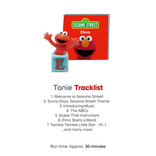 Elmo audio figurine with blue base and letter E, beside Sesame Street Elmo card.