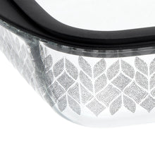Glass baking dish side close-up with leaf-and-diamond patterned design