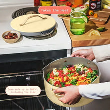 Buttercream covered skillet cooking vegetables on stove, held by two hands