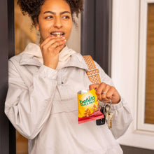 Woman holding a belVita snack pack and car keys