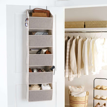 Gray over-the-door closet organizer with five fabric shelves and side hooks