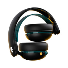 Black over-ear headphones folded with teal strap and padded earcups
