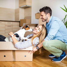 Dog playpen delivery box with dog and family nearby on indoor floor