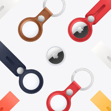 Apple AirTag trackers on leather key fobs in brown, red, and navy, multiple shown