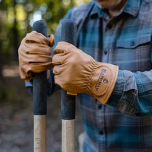 Brown cabretta leather gloves on hands, textured knuckles and stitched cuffs
