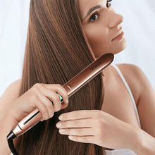 Rose-gold hair straightener held to a woman’s long straight hair