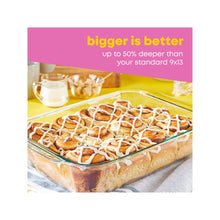 Rectangular glass baking dish with lid, cinnamon rolls topped with icing, clear Pyrex