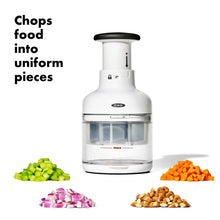 White food chopper with clear container and mixed chopped vegetables