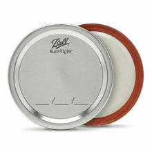 Two SureTight mason jar lid parts: metal lid and flat insert