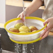 Yellow vented splatter cover over a bowl as water pours for cleaning