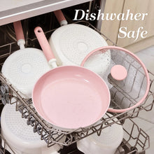 Pink ceramic nonstick frying pan and lid basket set shown on a dishwasher rack