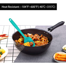 Teal silicone spatula stirring food in a nonstick skillet