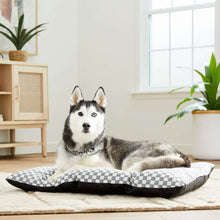 Black-and-white checkered dog bed pillow with quilted tufted top
