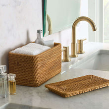 Brown rattan organizer basket with closed lid on countertop, woven basket body.