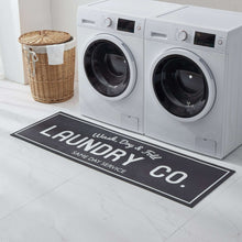 Black indoor laundry runner rug with large 'LAUNDRY CO.' logo and 'Same Day Service'