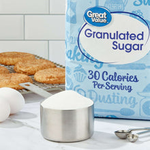 Granulated sugar container with sugar bag and cookies beside it