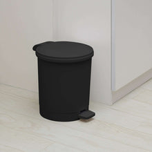 Black plastic bathroom trash can with foot pedal and closed round lid