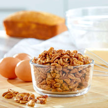 Glass bowl filled with chopped pecans